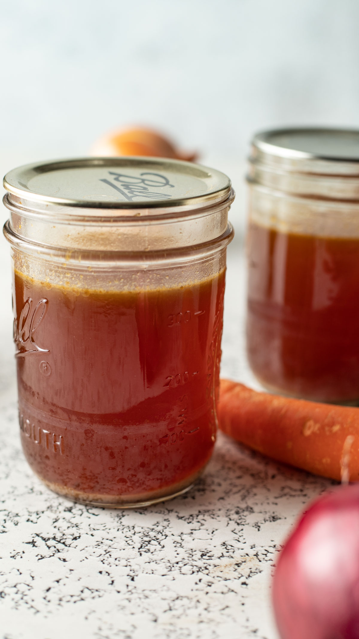 Strained bone stock in jars.