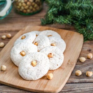Hazelnut macaroons on wooden board.