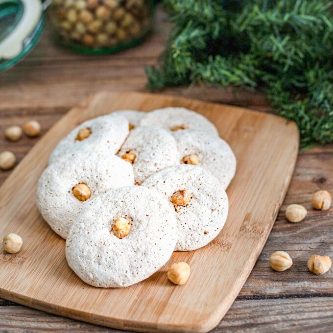 Hazelnut macaroons on wooden board.