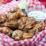 Crispy air fried chicken wings in basket.