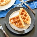 2 Belgian waffles on whit and black plate.
