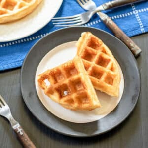 2 Belgian waffles on whit and black plate.