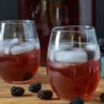Blackberry tea in glasses garnished with blackberries.