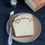 Slices of white bread on beige plate with blue trim.