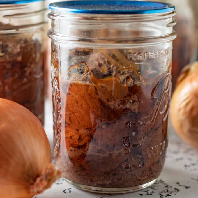 Close up of canned deer meat in a pint jar.