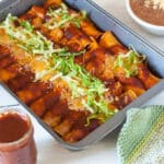 Tray of enchiladas on metal baking pan.