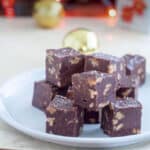 Pieces of fudge piled on a white plate.