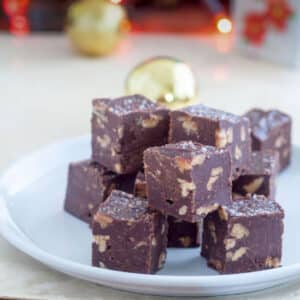 Pieces of fudge piled on a white plate.