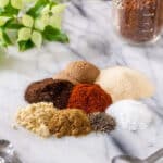 Spices for pork dry rub on marble board.