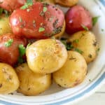 Red and white potatoes in white bowl.