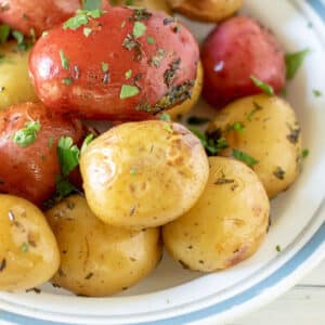 Red and white potatoes in white bowl.