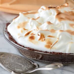 Lemon meringue pie with chocolate crust and browned meringue.