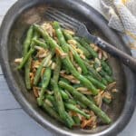 Green beans with almonds in antique pewter bowl.