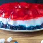 Red, white and blue jello salad on white platter.