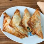 lobster pastries triangle on white plate.