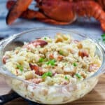 Lobster mac and cheese in a glass dish.
