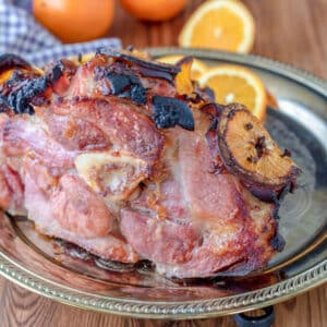 Cooked ham roast with pineapple slices.