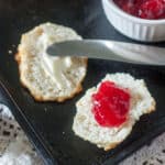 Plum jam spread onto homemade biscuits.