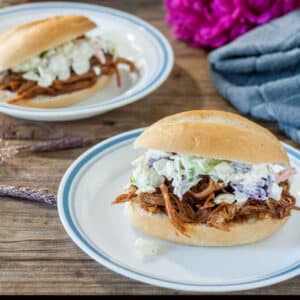 Pulled pork sandwiches topped with coleslaw on hard rolls.