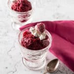 Pink raspberry sorbet in dessert fluted dishes.