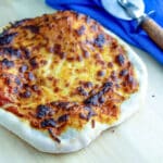 Sourdough pizza on pizza peel.