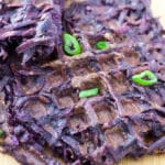 Sweet potato waffles with scallion garnish.