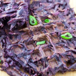 Sweet potato waffles with scallion garnish.