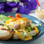 Turkey burger on buns covered with chipotle sauce.