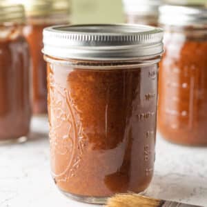 Close up of jars of apricot bbw sauce.