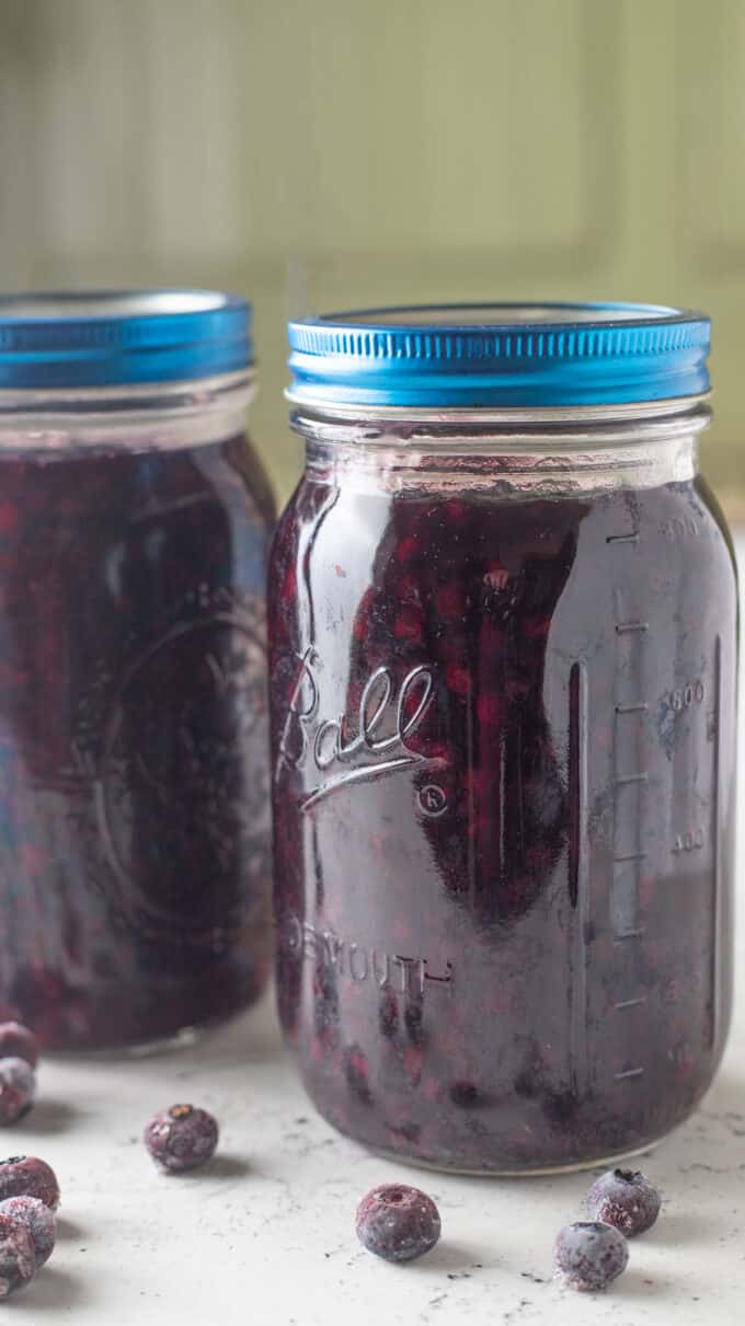 Jars of filling with blue lids.