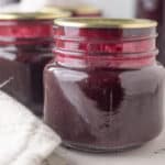 Close up of jars of blueberry syrup.