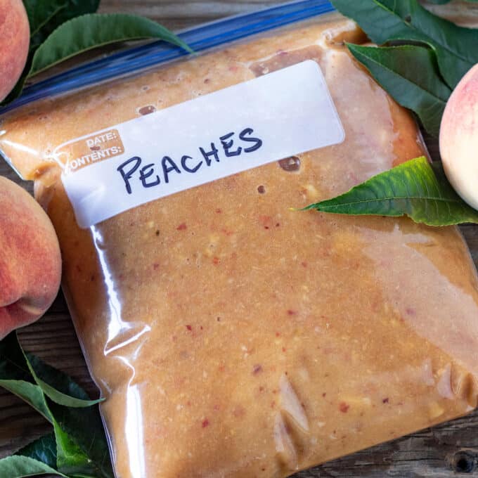 Close up of frozen peach purée in freezer bag.