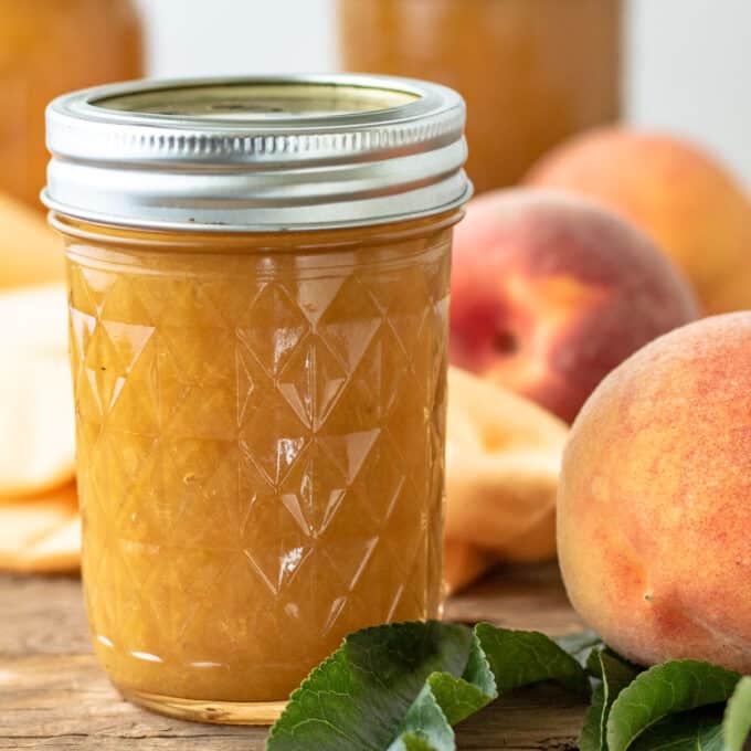 Close up of jar of peach syrup.