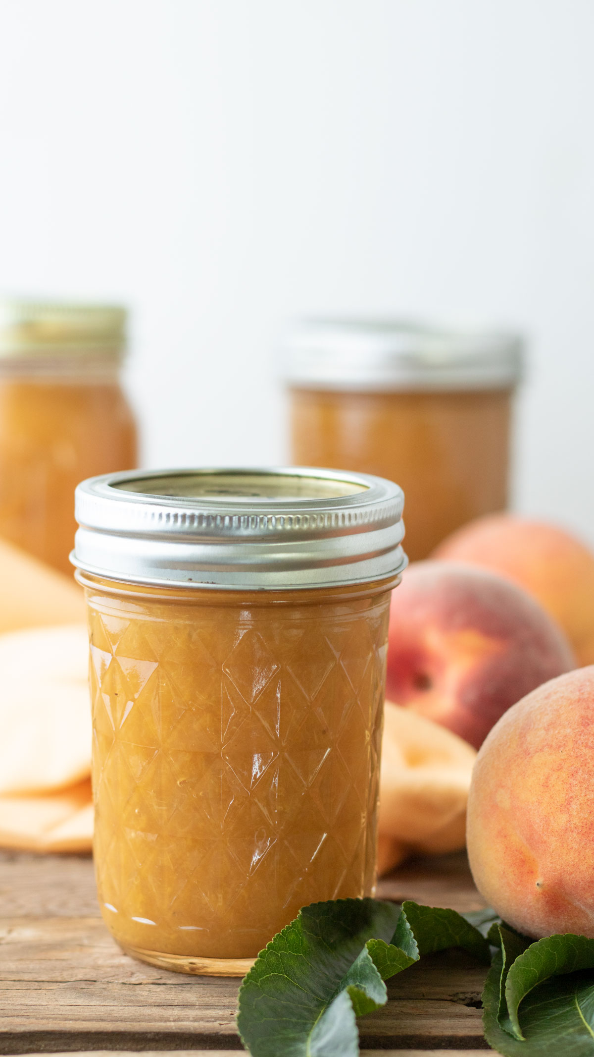 Jars of homemade peach syrup.