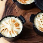 3 individual shepherd's pie on wood slab.