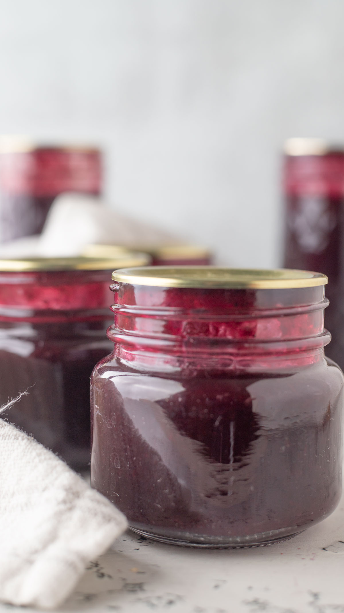 Blueberry syrup in canning jars.