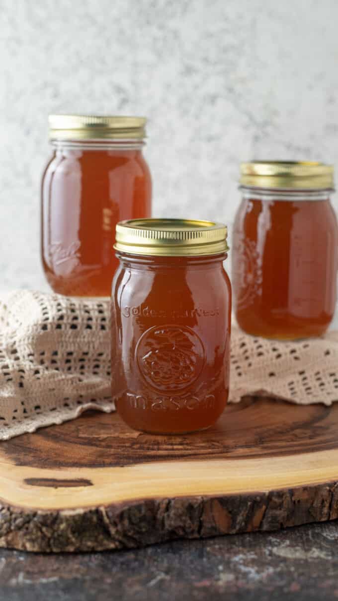 Jars of syrup on antique doily.