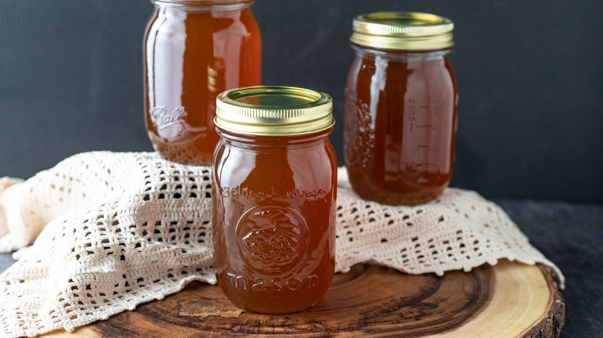Syrup in jars with black background.