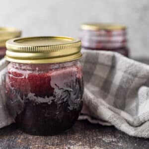 Close up of jar of raspberry syrup.