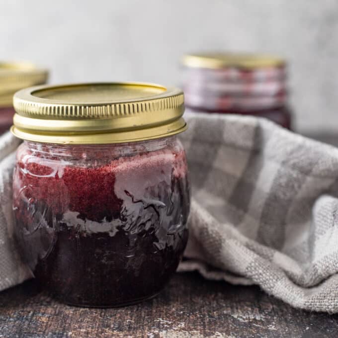Close up of jar of raspberry syrup.