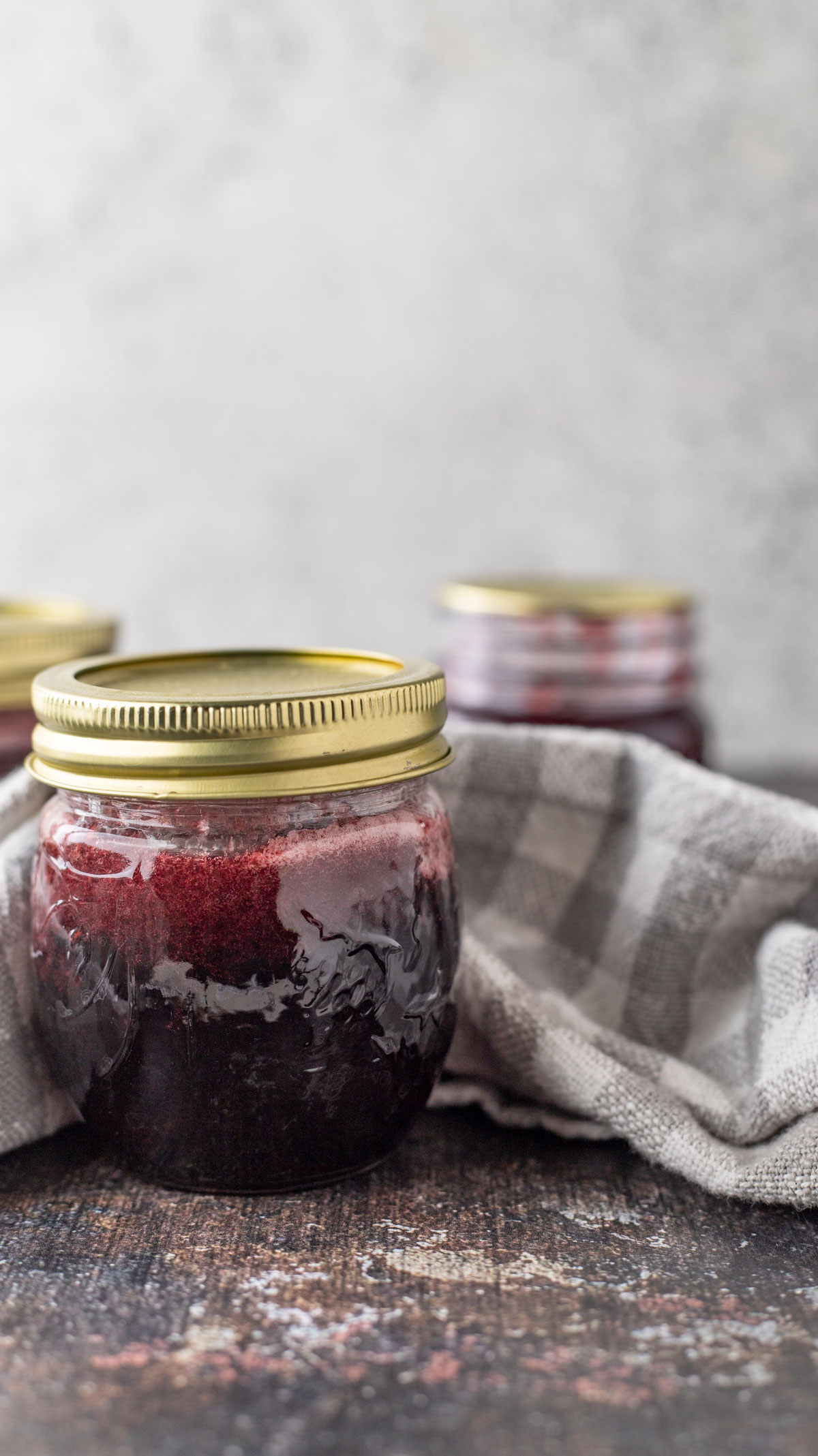 Syrup with white and gray checked kitchen towel.