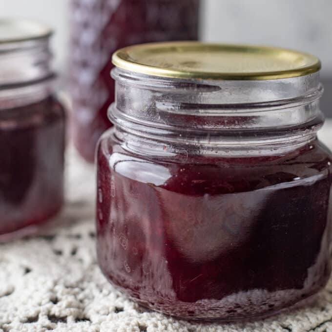Close up of jars of seedless raspberry jam.