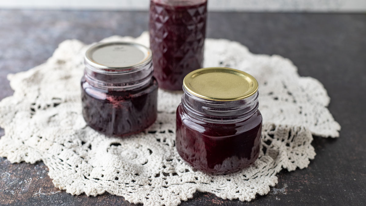 Jam jars on antiques doily.