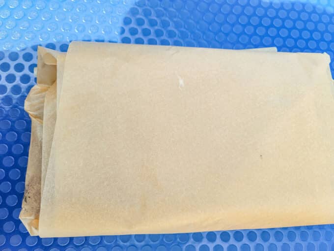 Meat wrapped in parchment paper.