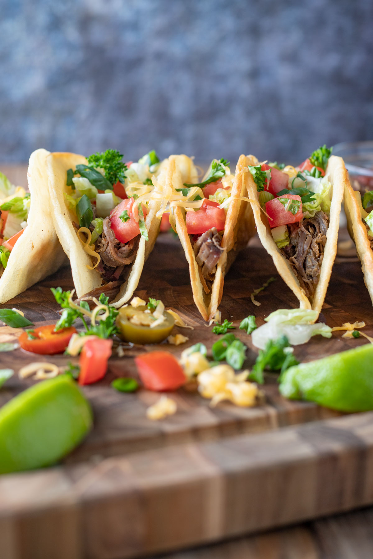 Group of tacos with colorful garnish.