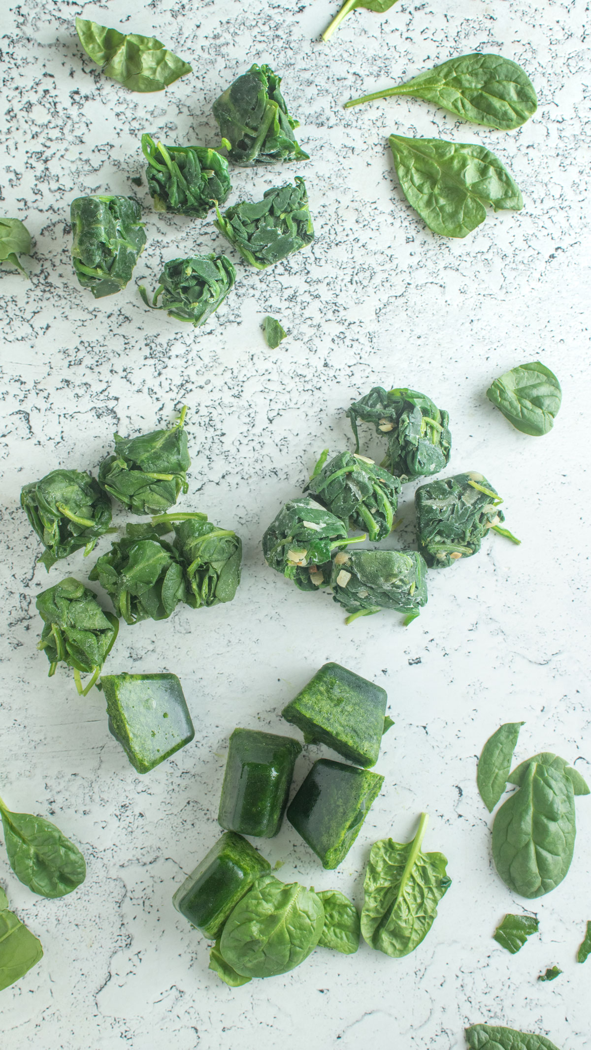 4 types of frozen spinach on white board.