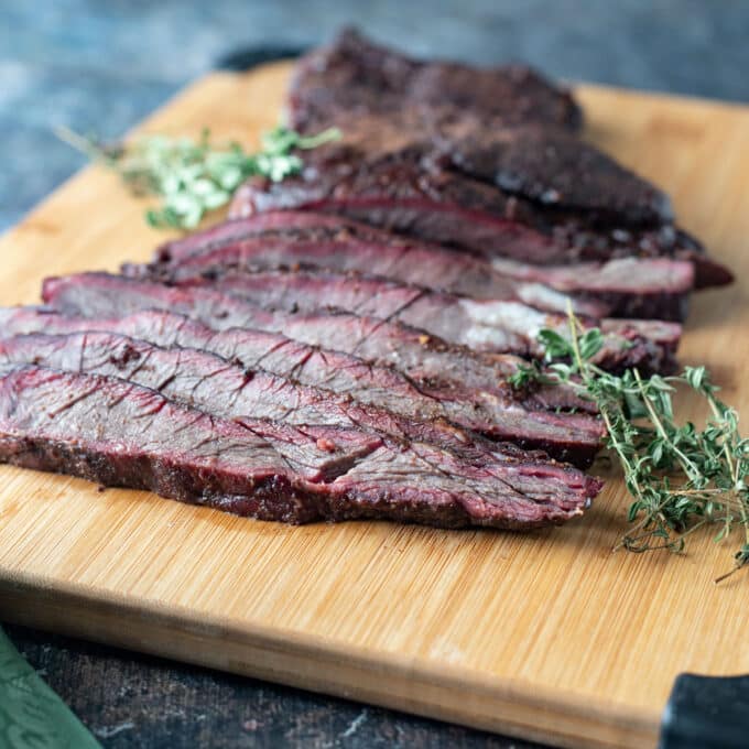 Sliced venison brisket on cutting board.