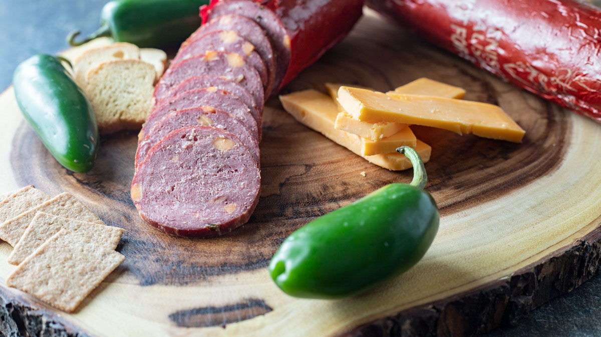 Sliced summer sausage with cheese and jalapeños.