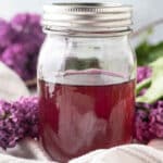 Close up of lilac syrup in jar.