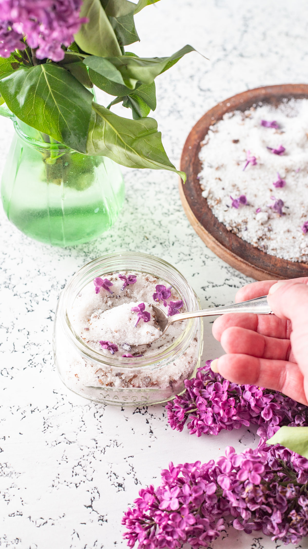 Spoon scooping sugar out of jar.
